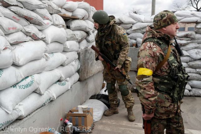 Members of the Ukrainian Territorial Defence Forces are seen at a checkpoint in Kyiv